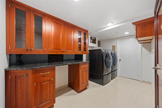 clothes washing area with cabinets and washer and clothes dryer