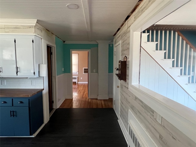 hall featuring dark wood-type flooring and radiator heating unit