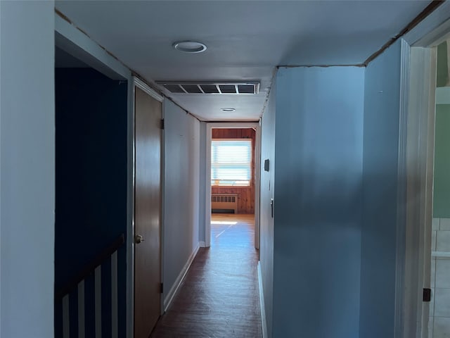 corridor with radiator and hardwood / wood-style flooring