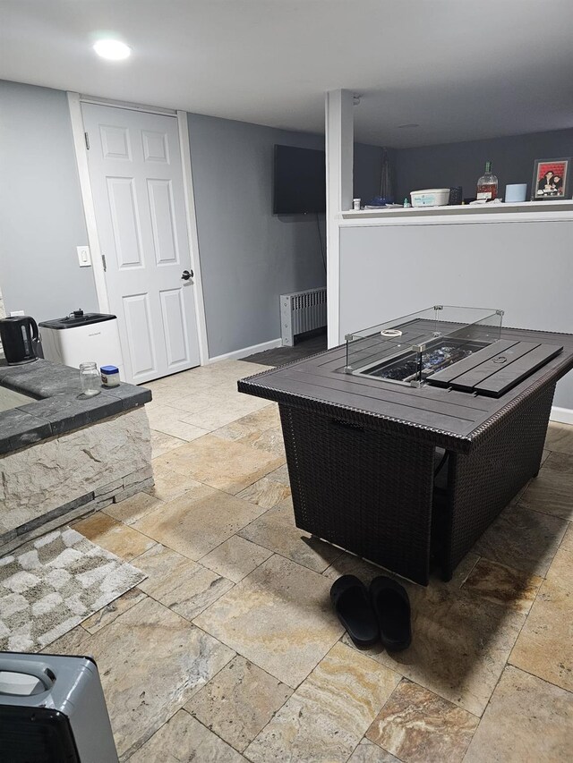 kitchen featuring baseboards and stone tile flooring