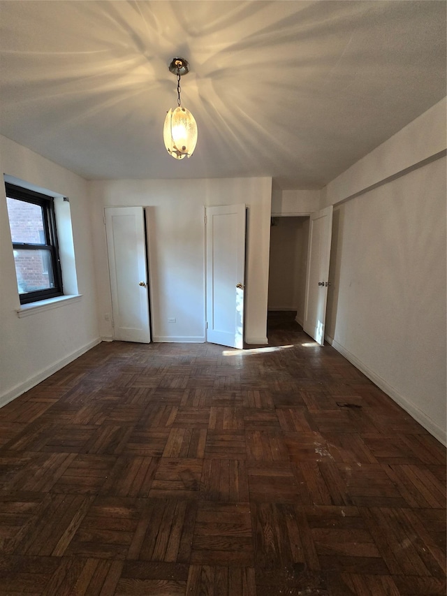 unfurnished room featuring dark parquet floors