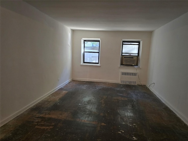 unfurnished room featuring cooling unit and radiator