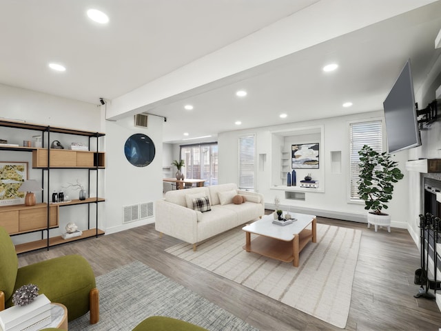 living room with hardwood / wood-style flooring and beamed ceiling