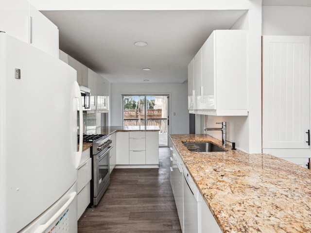 kitchen featuring sink, dark wood-type flooring, appliances with stainless steel finishes, light stone countertops, and white cabinets