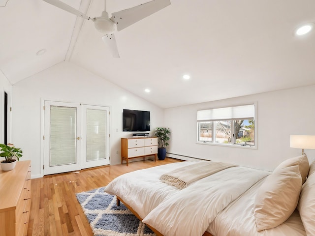 bedroom featuring lofted ceiling, a baseboard heating unit, and light hardwood / wood-style flooring