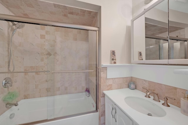 bathroom featuring vanity and combined bath / shower with glass door