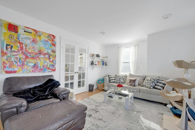 living room featuring french doors and light hardwood / wood-style flooring