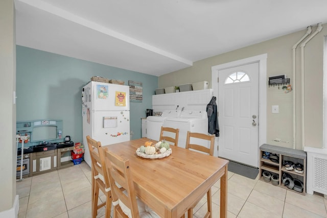 tiled dining area featuring washer and clothes dryer