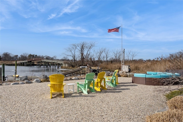 view of play area with an outdoor hangout area and a water view