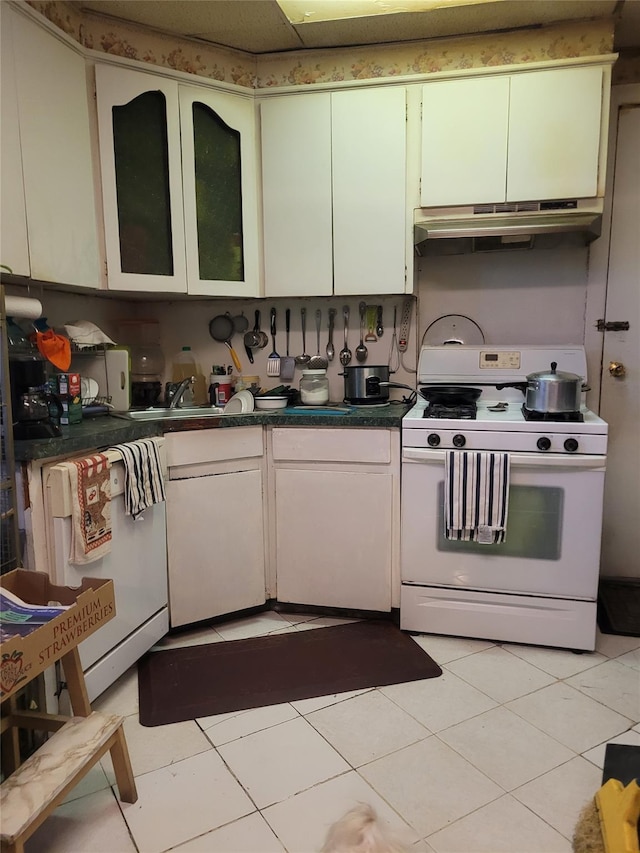 kitchen with sink, white appliances, and light tile patterned flooring