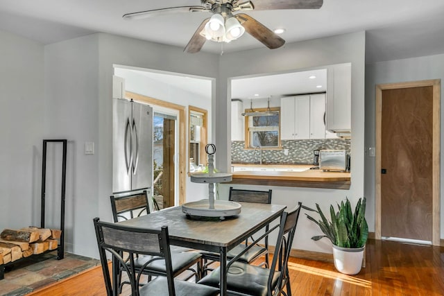 dining space featuring hardwood / wood-style flooring and ceiling fan