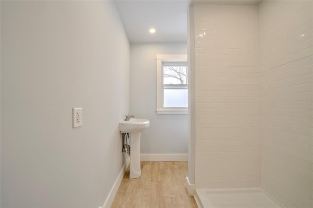 bathroom with a shower and hardwood / wood-style floors