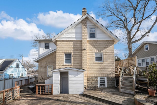 rear view of house featuring a wooden deck