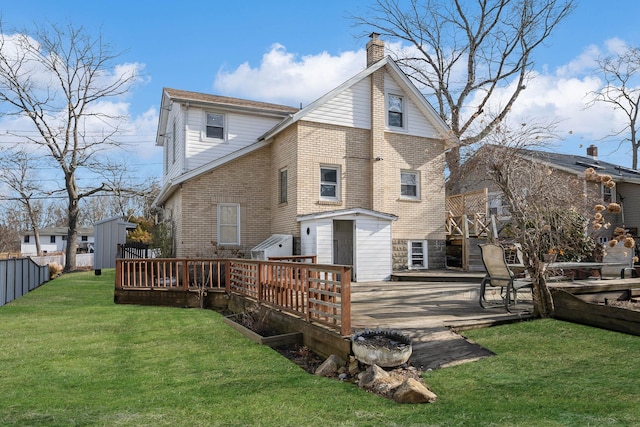 back of house with a wooden deck, a yard, a patio area, and a storage shed