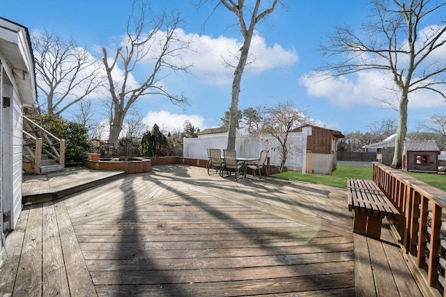 wooden terrace featuring a shed