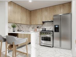 kitchen featuring stove, stainless steel fridge, and backsplash