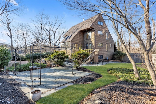 exterior space with a patio and a lawn