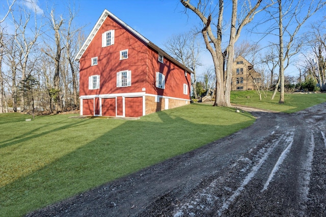 view of property exterior with a yard and a garage