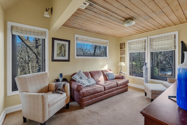 carpeted living room with wood ceiling