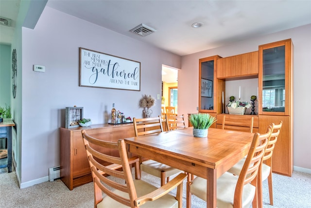 39 Cornwallis Rd, East Setauket, NY 11733 - dining area featuring a baseboard heating unit, light carpet, and baseboards