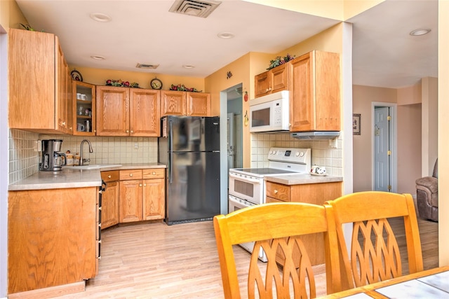 39 Cornwallis Rd, East Setauket, NY 11733 - kitchen with white appliances, a sink, light wood-style floors, light countertops, and tasteful backsplash