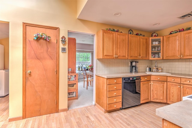 39 Cornwallis Rd, East Setauket, NY 11733 - kitchen featuring dishwasher, light countertops, light wood-style floors, a sink, and tasteful backsplash