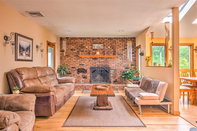 39 Cornwallis Rd, East Setauket, NY 11733 - living room with light wood-style flooring and a fireplace