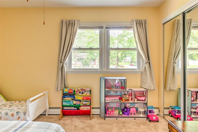 39 Cornwallis Rd, East Setauket, NY 11733 - carpeted bedroom featuring multiple windows and a baseboard radiator