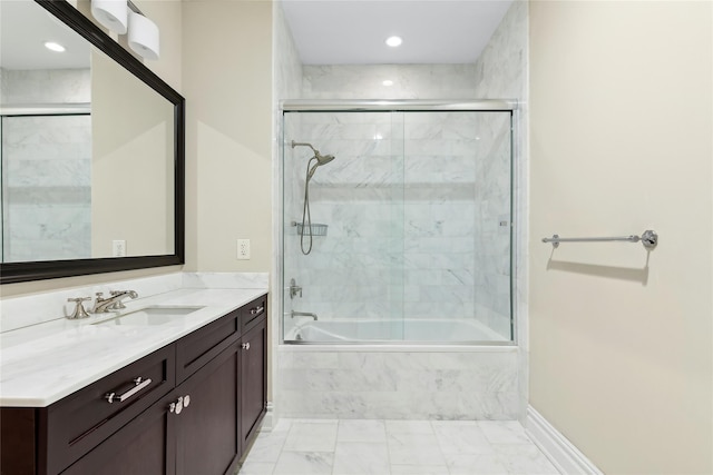 bathroom with enclosed tub / shower combo and vanity