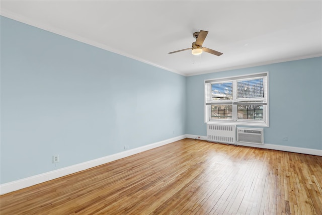 unfurnished room featuring baseboards, light wood-style floors, ornamental molding, and radiator