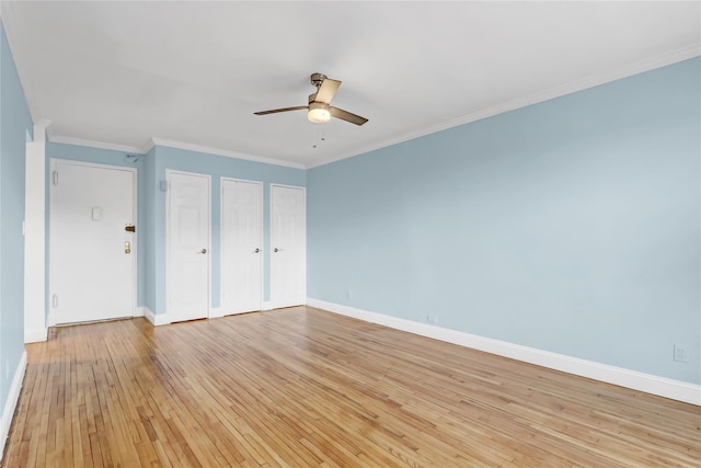 unfurnished bedroom featuring a ceiling fan, baseboards, multiple closets, ornamental molding, and light wood finished floors