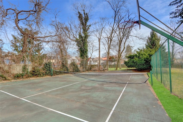 view of sport court featuring fence