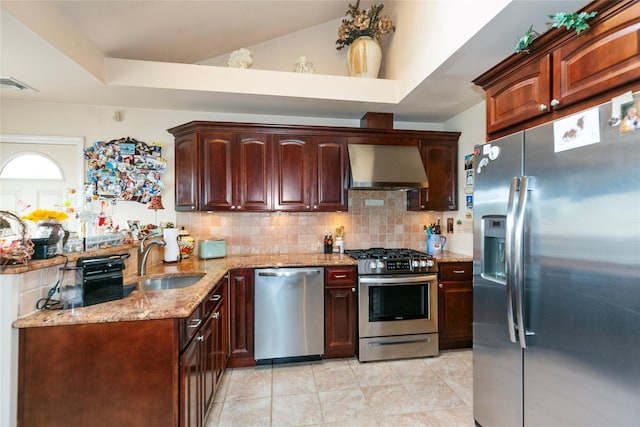 kitchen featuring light stone counters, visible vents, backsplash, appliances with stainless steel finishes, and wall chimney exhaust hood