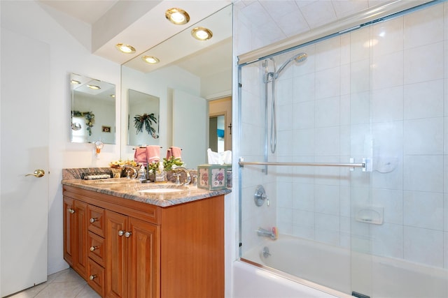 bathroom with bath / shower combo with glass door, tile patterned floors, a sink, and double vanity