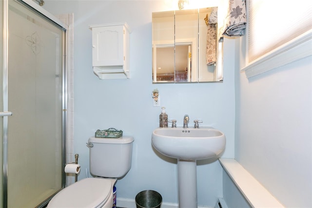 full bath with a shower with shower door and toilet