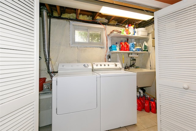 washroom with washer and dryer, laundry area, a sink, and light tile patterned floors