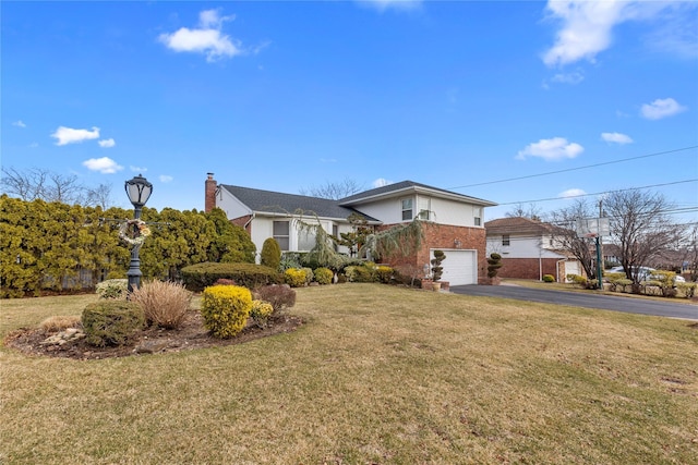 view of front facade with driveway, brick siding, an attached garage, and a front yard