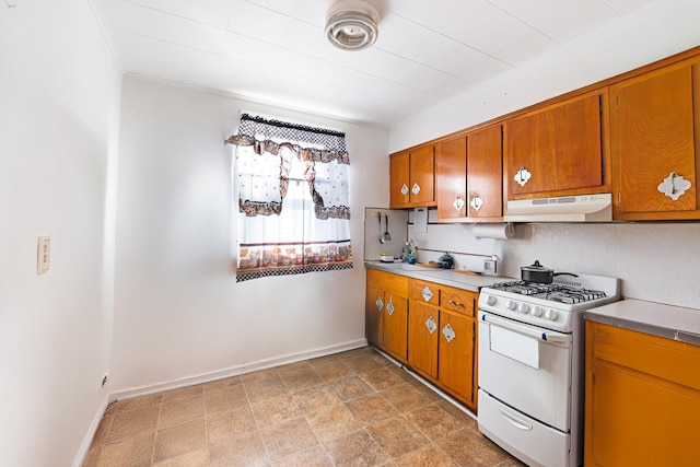 kitchen with ornamental molding and white range with gas stovetop