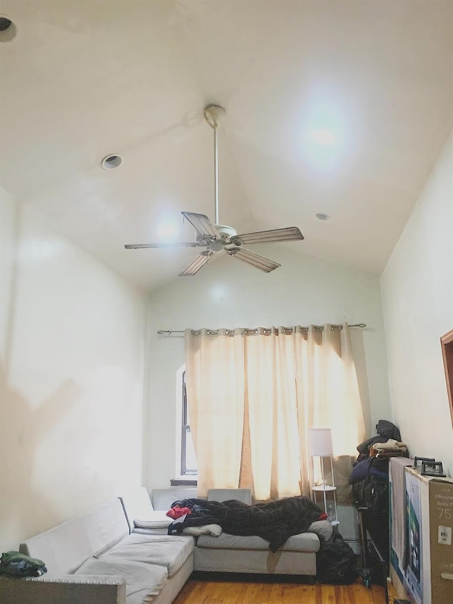 living room with ceiling fan, vaulted ceiling, and hardwood / wood-style floors