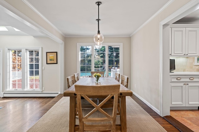 dining area with dark wood-style floors, a baseboard radiator, and crown molding