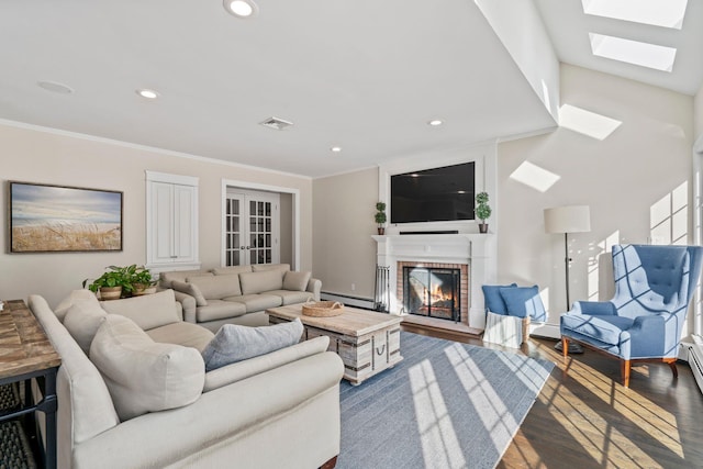 living room featuring crown molding, recessed lighting, a baseboard heating unit, a brick fireplace, and wood finished floors