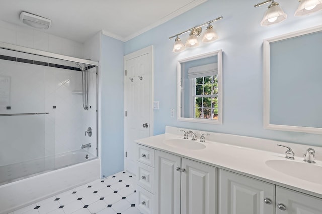 bathroom featuring ornamental molding, combined bath / shower with glass door, a sink, and double vanity