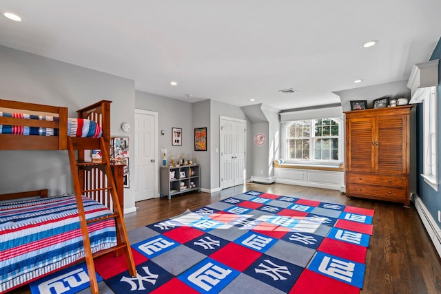 bedroom featuring baseboards, visible vents, dark wood-type flooring, a baseboard heating unit, and recessed lighting