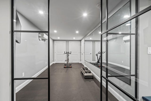 exercise area featuring recessed lighting and baseboards