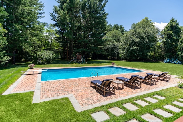 outdoor pool featuring playground community, a lawn, and a patio