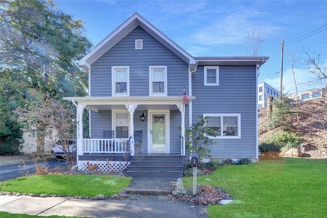 view of front of home with a porch and a front lawn