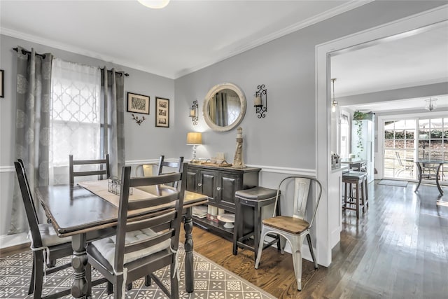 dining room featuring crown molding and hardwood / wood-style flooring