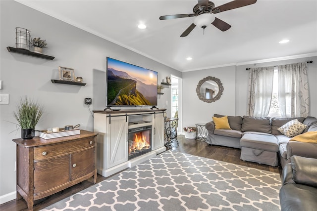 living room featuring crown molding, ceiling fan, and dark hardwood / wood-style flooring