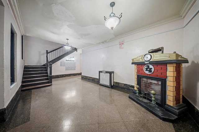 unfurnished living room featuring crown molding, granite finish floor, stairway, a brick fireplace, and baseboards