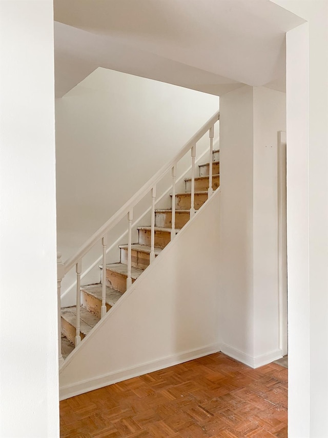 stairs featuring parquet floors